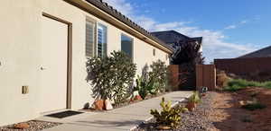 View of property exterior with a gate and stucco siding