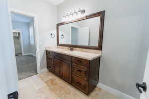 Bathroom featuring vanity and light colored carpet