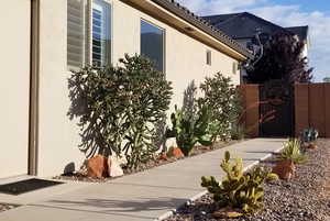 View of home's exterior with a gate and stucco siding