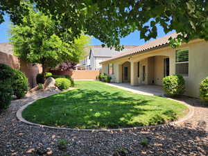 Fenced backyard with a patio area