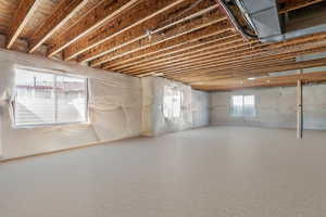 Unfinished basement with large windows