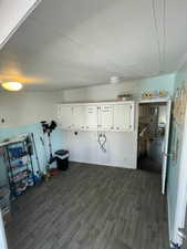 Interior space with dark wood-style floors and a wainscoted wall