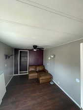 Unfurnished room with dark wood-type flooring, a textured ceiling, and a ceiling fan