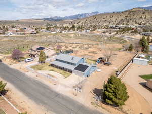 Aerial view of sparsely populated area with nearby suburban area and mountains