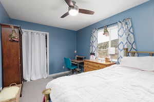Bedroom featuring ceiling fan and carpet flooring