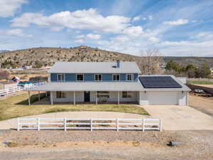 Country-style home with a metal roof, a mountain view, and solar panels