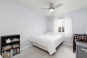 Bedroom with light carpet and ceiling fan