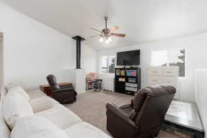 Living area with carpet, lofted ceiling, and a ceiling fan