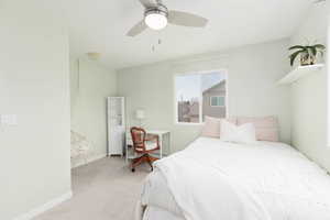 Bedroom with carpet floors, a desk, and ceiling fan