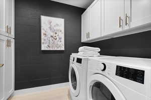 Laundry room with cabinet space, washing machine and dryer, and sink