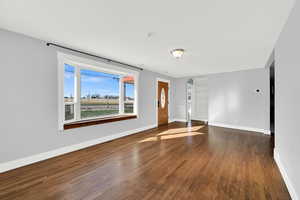 Front living room with hardwood floors and bay window. Lots of natural light