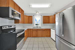 Kitchen with several new appliances and sink/faucet.