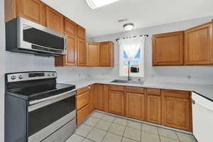 Kitchen with several new appliances and sink/faucet.