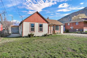 Front of single level home with view of side gate