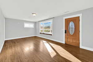 Front living room with hardwood floors and bay window. Lots of natural light