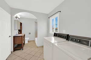 Laundry/mudroom space in bathroom, with view of full bathroom