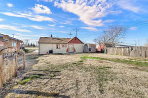 Back of house with patio, shed, and view of parking/fence