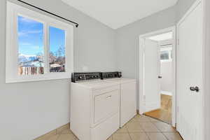 Laundry space in bathroom with entry to bedroom