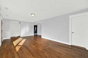 Front living room with hardwood floors and bay window. Lots of natural light and charming built-ins