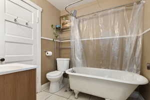 Bathroom with a freestanding tub, light tile patterned floors, and vanity