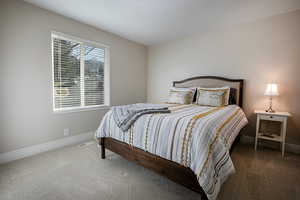 Carpeted bedroom with baseboards
