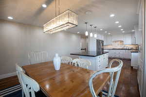 Dining area featuring recessed lighting and dark wood-type flooring