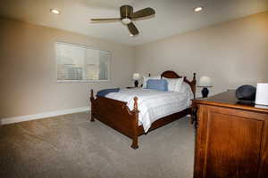 Carpeted bedroom featuring ceiling fan and recessed lighting