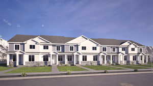 View of front facade featuring stone siding, a front lawn, and covered porch