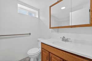 Half bath featuring vanity and toilet