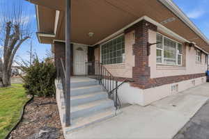 Doorway to property with brick siding