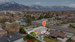 Aerial perspective of suburban area featuring a mountainous background and property boundaries highlighted