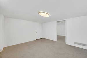 Unfurnished bedroom featuring a walk in closet