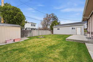 Fenced backyard with a storage shed