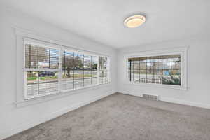 Carpeted spare room with baseboards