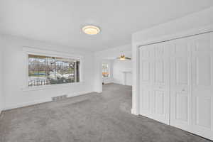 Unfurnished bedroom with carpet flooring and a closet