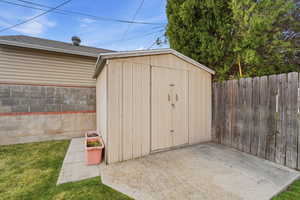 View of shed with a fenced backyard