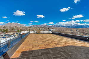 View of patio with a deck with mountain view