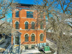 Italianate home featuring brick siding