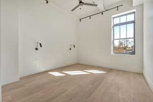 Unfurnished room featuring light wood finished floors and ceiling fan