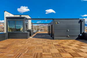 View of patio with a deck with mountain view