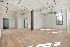 Unfurnished room with light wood-type flooring and rail lighting