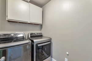 Laundry area with cabinet space and independent washer and dryer