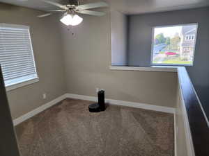 Spare room with carpet flooring and ceiling fan