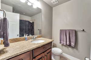 Full bath featuring vanity, a shower with curtain, and light tile patterned floors