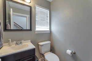 Half bath featuring toilet and vanity