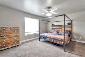 Bedroom featuring light colored carpet and ceiling fan