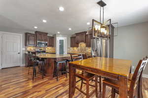 Dining space featuring light wood-style flooring and a chandelier