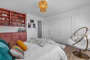 Bedroom with light wood-style flooring and a closet