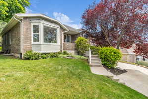 Brick exterior featuring a prominent bay window with white trim
