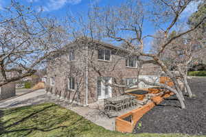 Rear view of property featuring a patio area